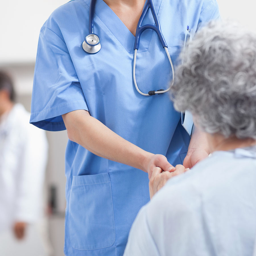 Nurse extending hand to care for elderly patient