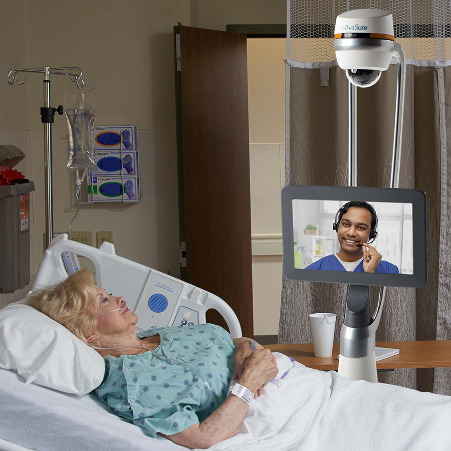 AvaSure Guardian® 2-Way Mobile Device with female patient in hospital bed talking to a TeleNurse on screen