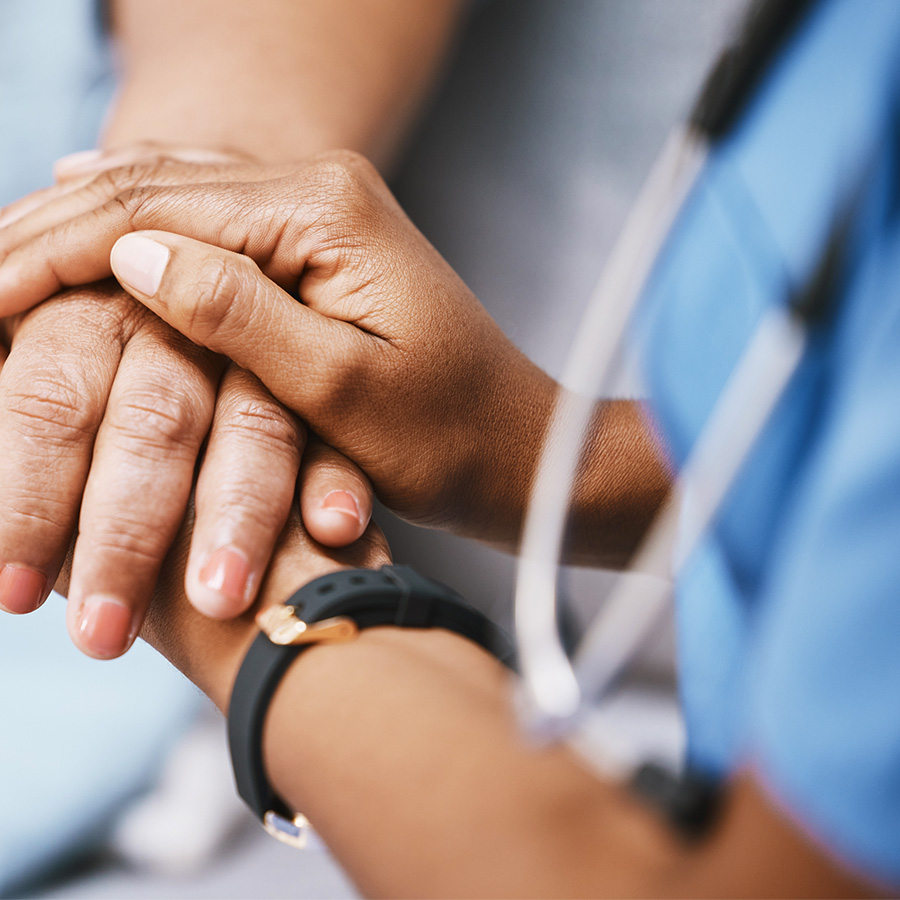 Nurse and patient are holding hands